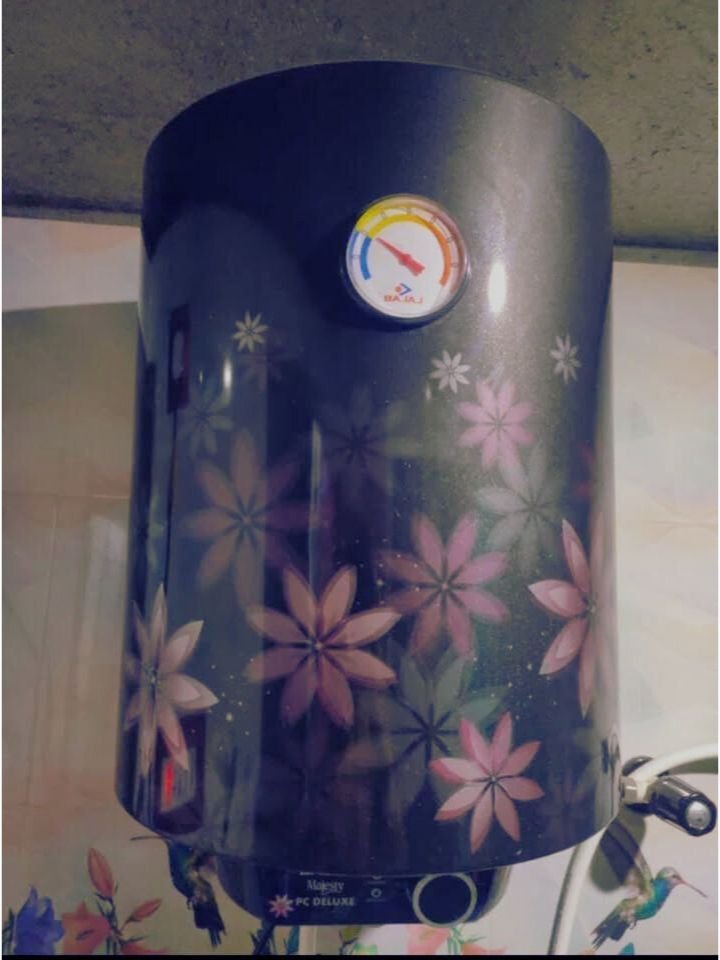 Bajaj Majesty PC Deluxe 15L geyser showing temperature control knob and analog heat indicator meter