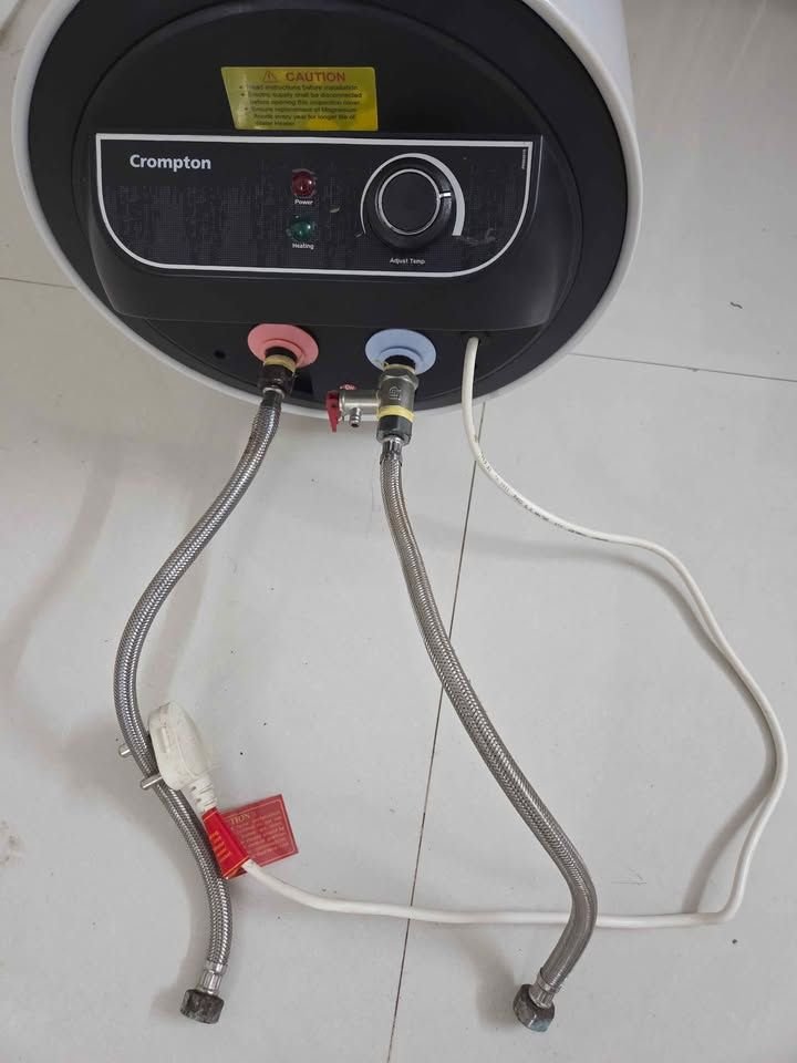 Close view of Crompton Amica 15 Litre Geyser hot water out and cold water inlet pipes